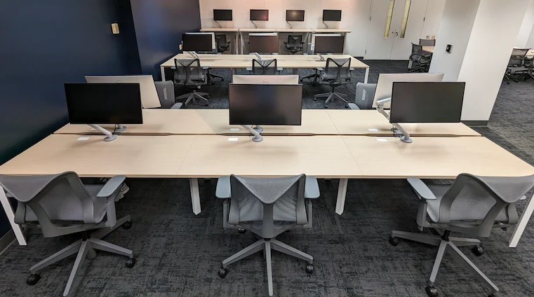 The renovated CSXL coworking space with shared desks, monitors, and ergonomic chairs