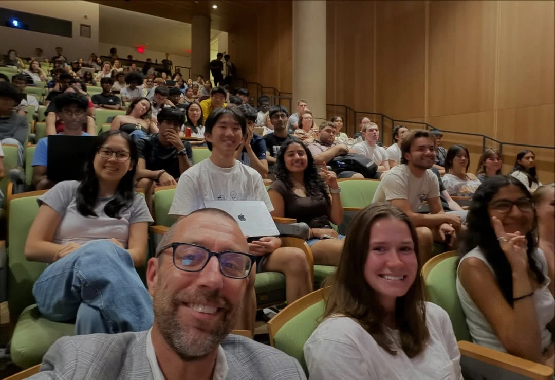 A selfie of Provost Magnus Egerstedt with COMP590 Honors AI Engineering students in the race-night audience